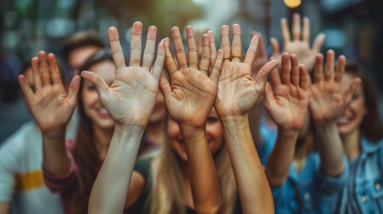 Office Team Unity – stock photo of coworkers showing solidarity with stacked hands in a workplace setting