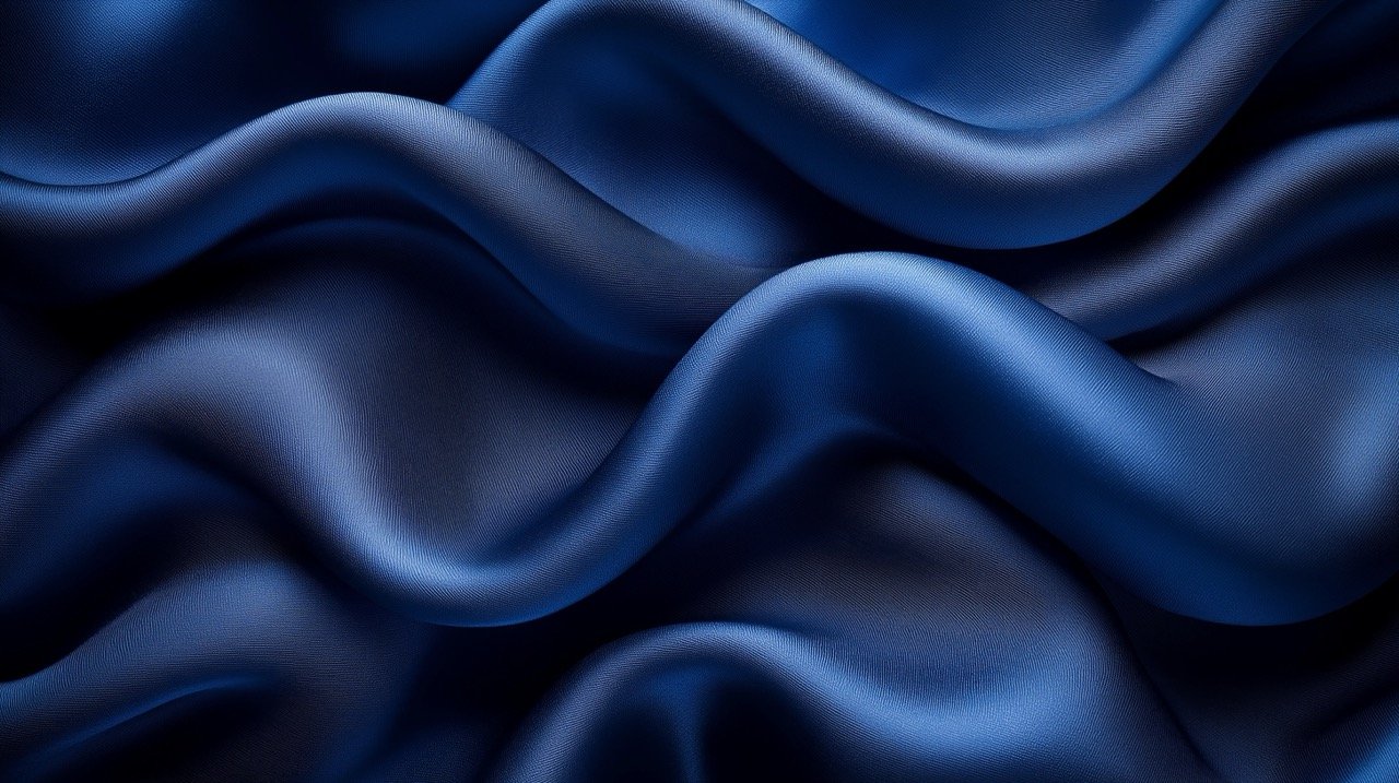 Elegant abstract dark blue background with silk satin texture, navy blue color for sophisticated design elements.