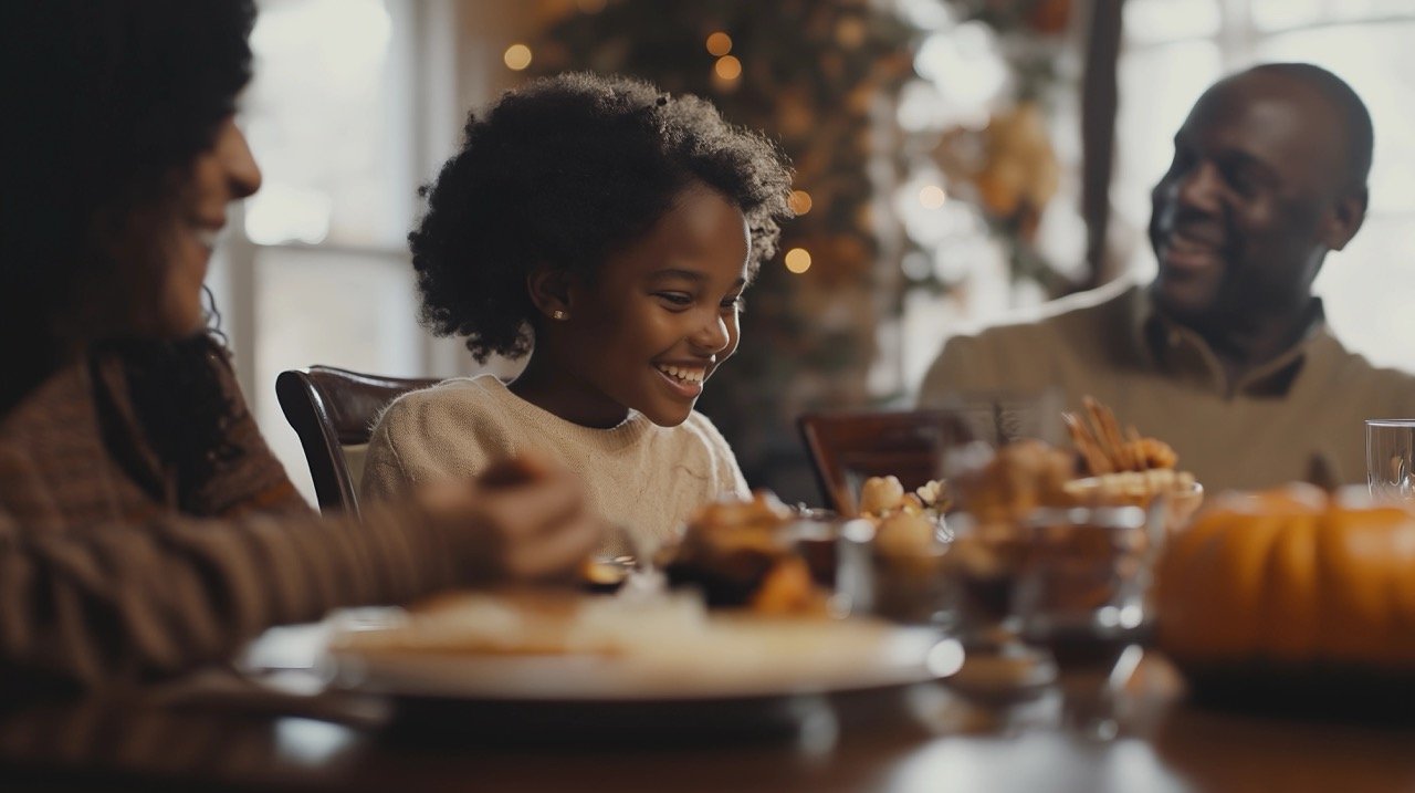 Happy African-American Girl Enjoying Thanksgiving Lunch with Parents Around Dining Table in Festive Celebration