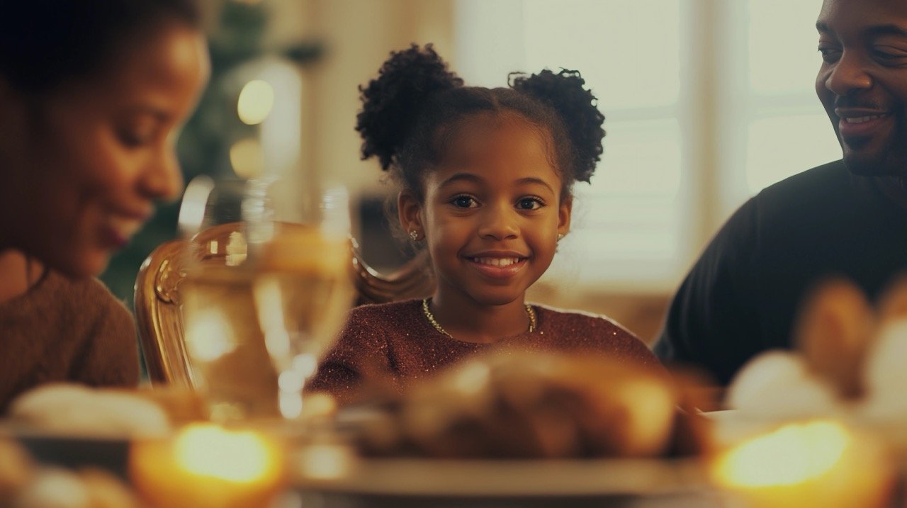 Joyful African-American Girl Celebrating Thanksgiving with Parents and Enjoying Family Meal at Dining Table