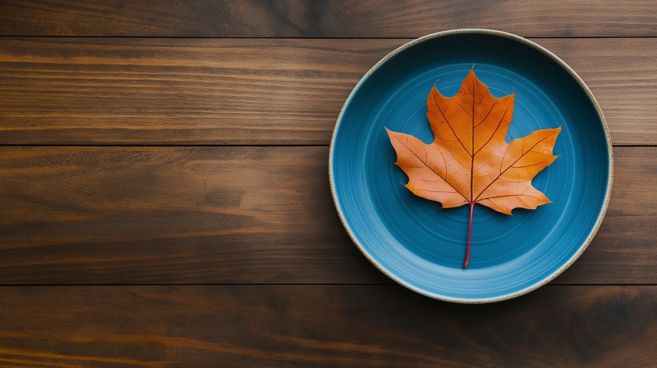 Thanksgiving Fall Aesthetic Blue Plate Topped with Autumn Orange and Brown Leaf Free Photo