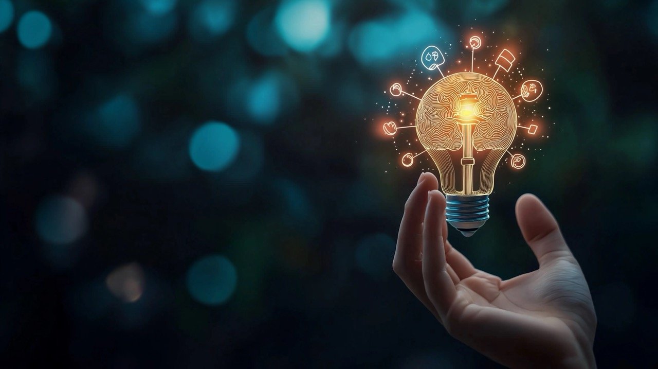 Hand Holding Virtual Lightbulb with Brain on Bokeh Background for Innovative Thinking and Smart Ideas